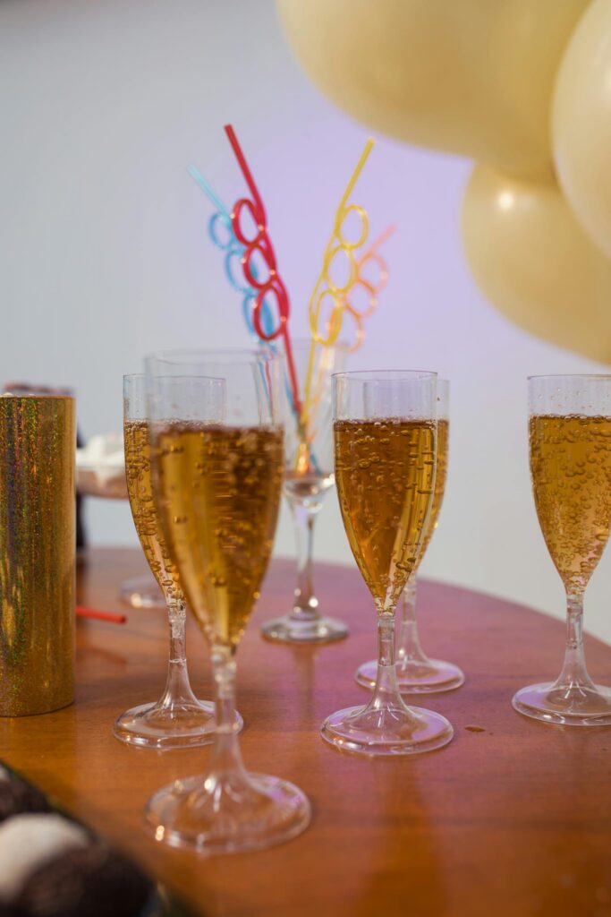 A festive table setting with sparkling drinks and colorful straws for a Brazilian celebration.