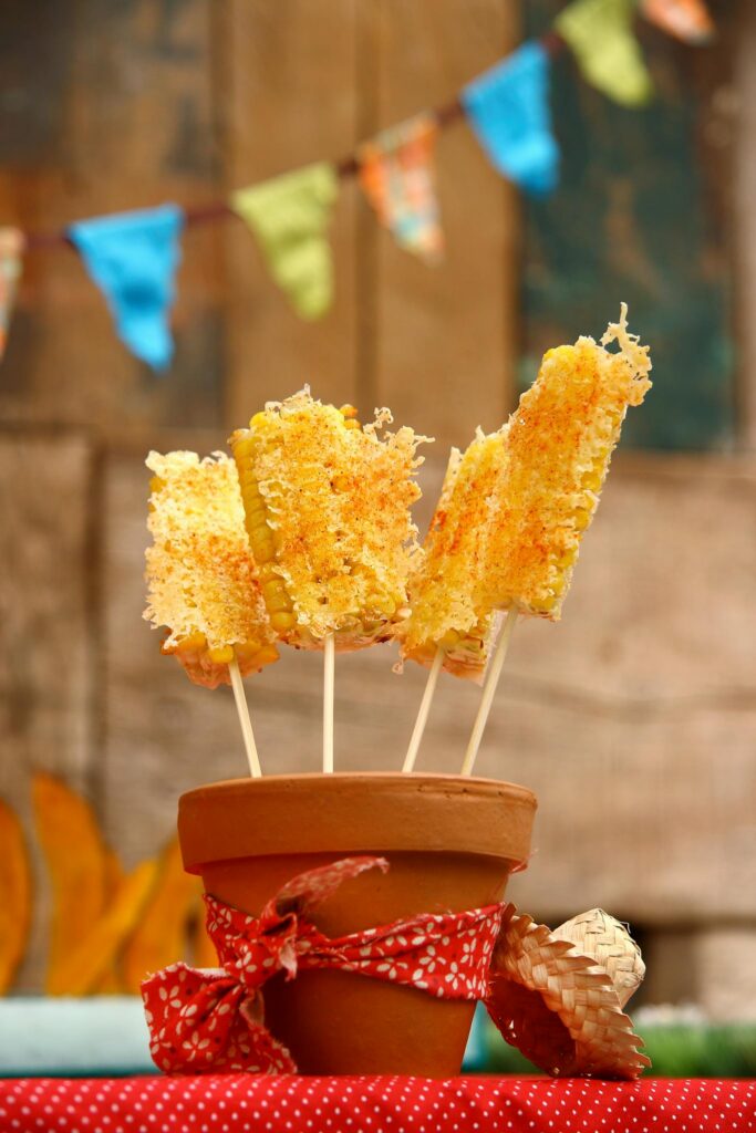 Cheese sticks on skewers in a flowerpot, Festa Junina style decor.