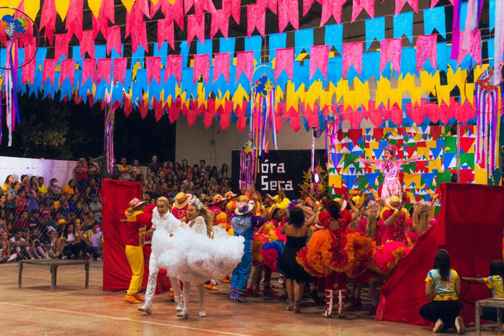 Colorful festival scene with dancers and decorations at a Brazilian celebration.